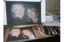 faces of a mother and daughter on easel. pastel portrait designed by a portrait artists in Brisbane