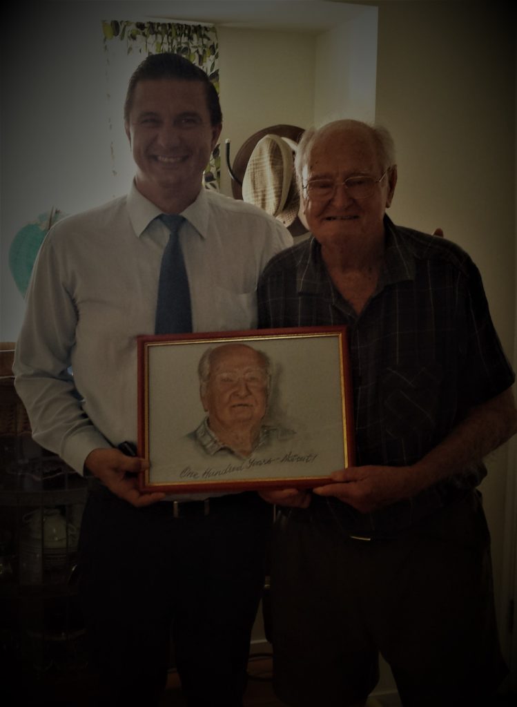 Portrait commission ofolder man holding their pastel portrait with artist from capalaba brisbane